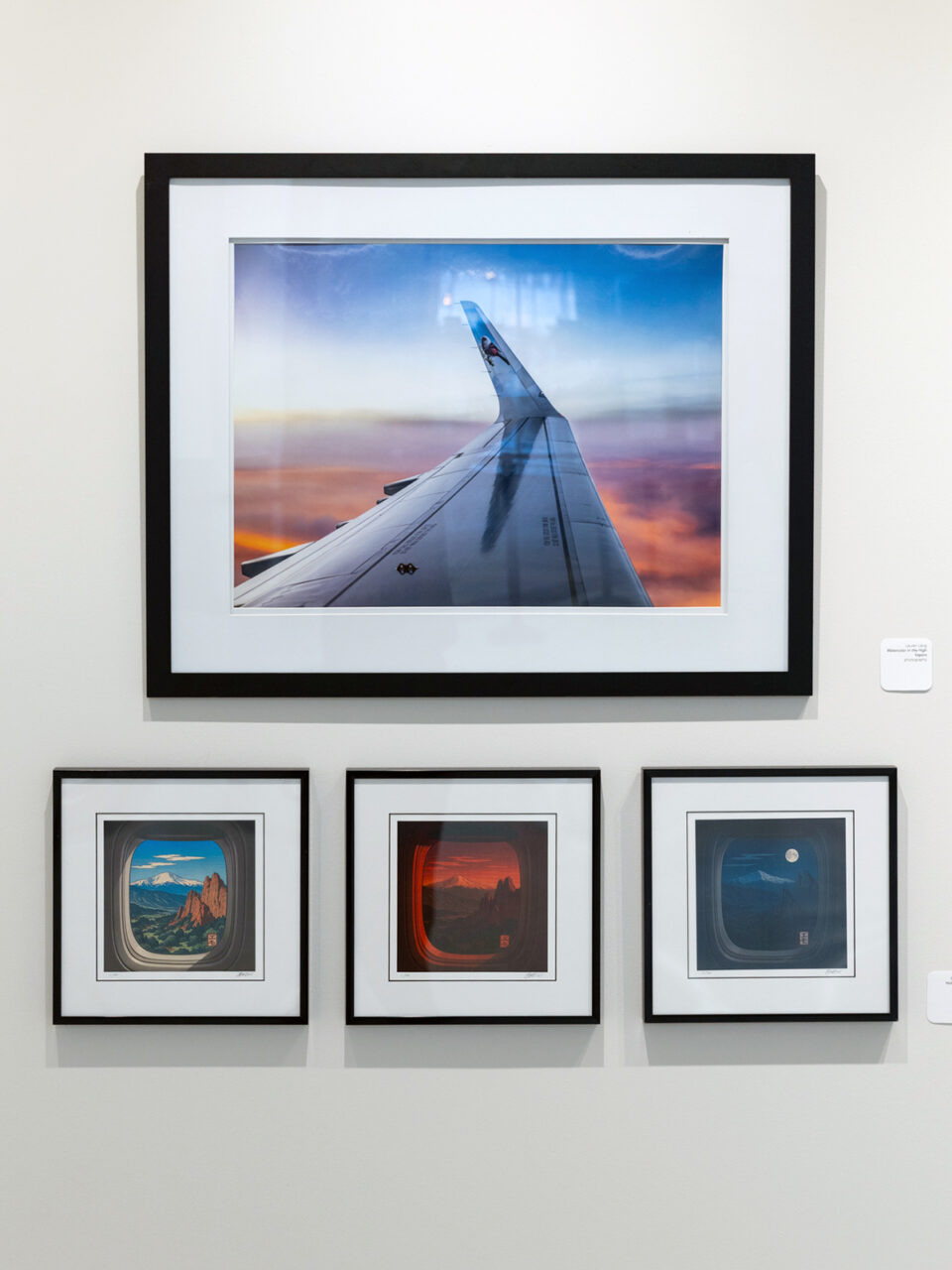 Four pieces of art on a wall inside the Colorado Springs Airport. They depict aviation things.