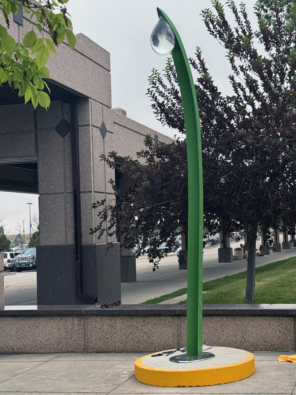 A long, green outdoor sculpture at Colorado Springs Airport