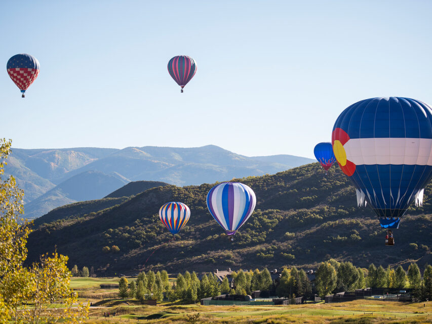 Hot air balloons hover over Snowmass village