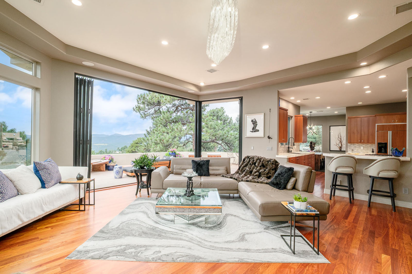 Living room with accordion glass doors open to the patio