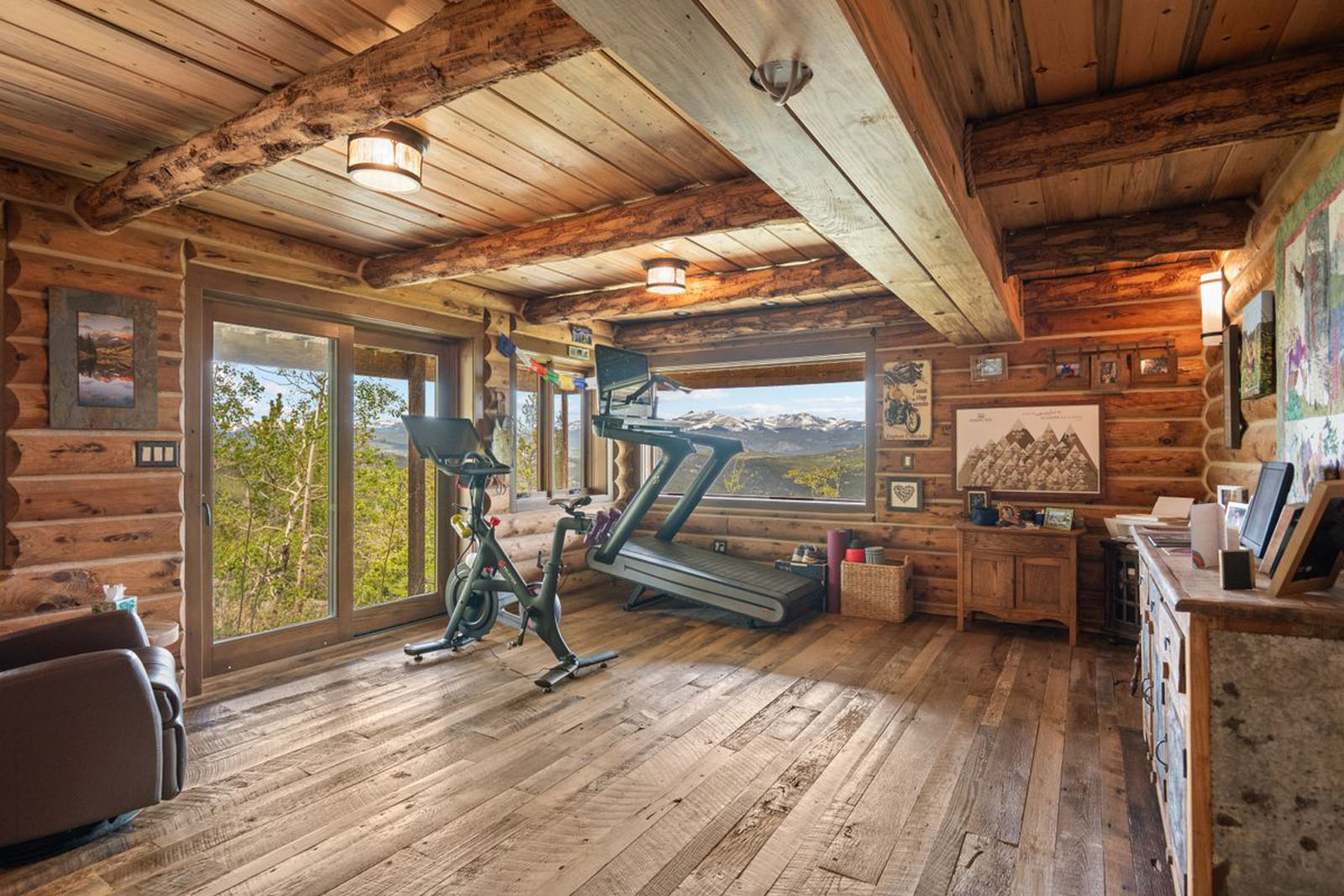 Log cabin room with workout equipment and large windows
