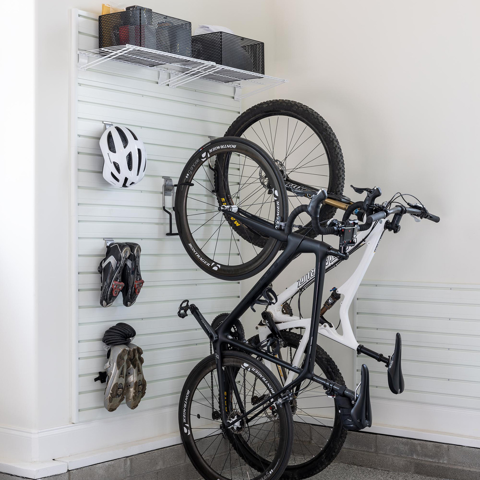 Bikes, helmets, cycling shoes hung on a wall